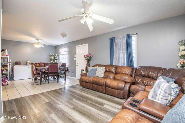 living area with ceiling fan and wood finished floors