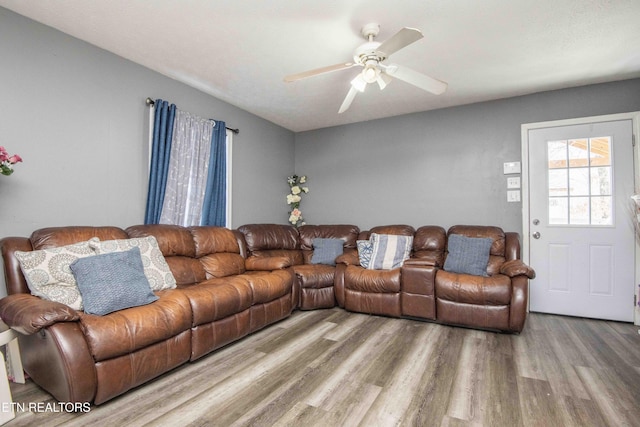 living room featuring ceiling fan and wood finished floors