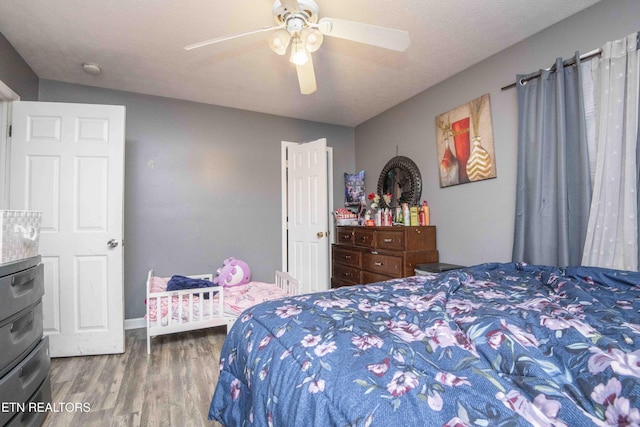 bedroom with wood finished floors and a ceiling fan