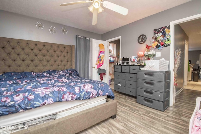 bedroom with a ceiling fan and wood finished floors