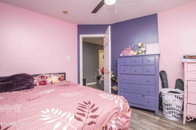 bedroom featuring wood finished floors and a ceiling fan