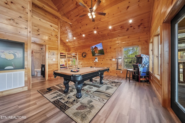 recreation room with visible vents, wood finished floors, pool table, wood walls, and high vaulted ceiling