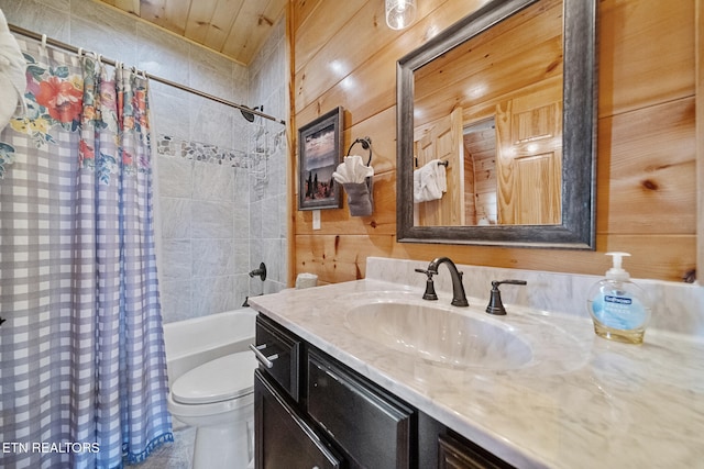 bathroom with toilet, wooden walls, vanity, and shower / tub combo with curtain