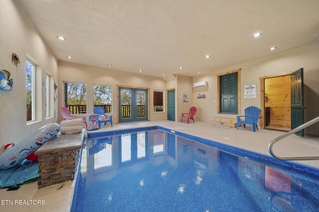 indoor pool with an AC wall unit and french doors