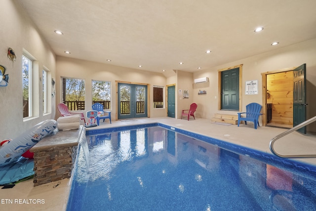 indoor pool with french doors and a wall unit AC