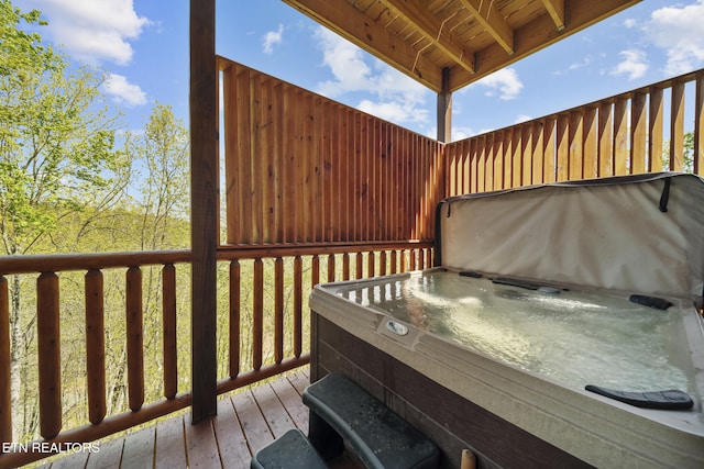 wooden terrace with a hot tub