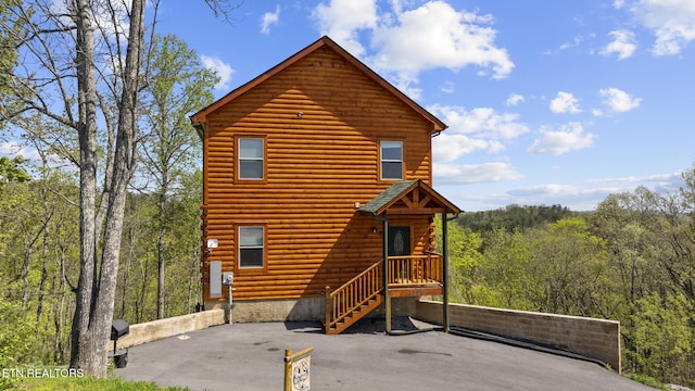 log-style house featuring a view of trees