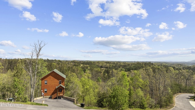 birds eye view of property with a view of trees