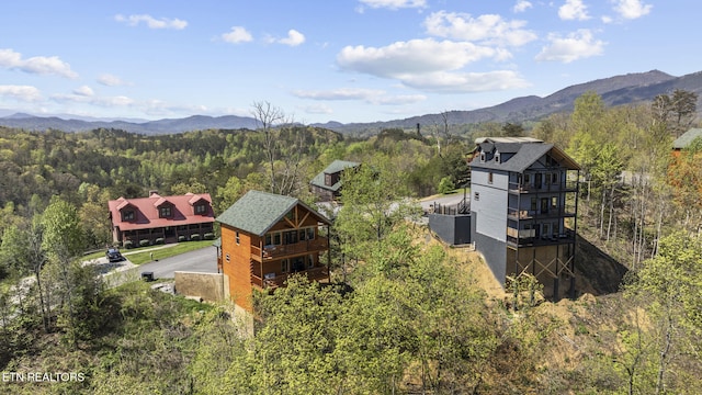 aerial view with a mountain view and a forest view