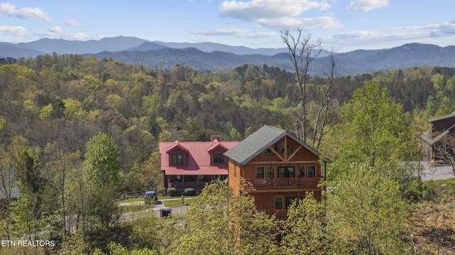 aerial view with a mountain view and a view of trees