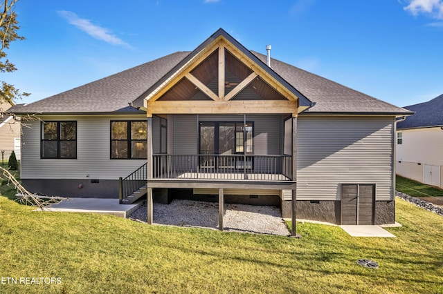 rear view of property featuring crawl space, a wooden deck, a patio, and a yard