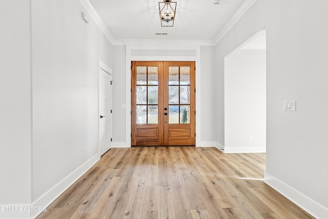 entryway with baseboards, french doors, light wood finished floors, and crown molding