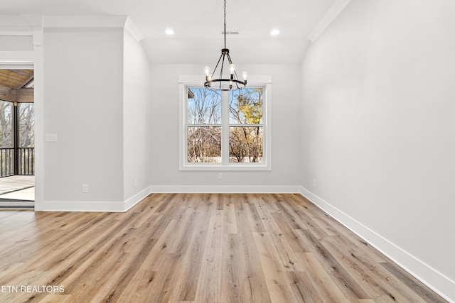 unfurnished dining area featuring a chandelier, a wealth of natural light, and baseboards