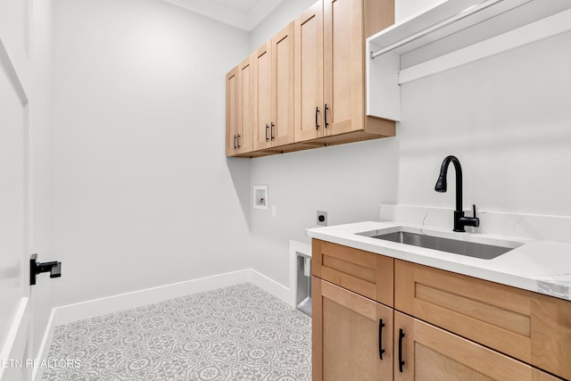 washroom with hookup for an electric dryer, washer hookup, a sink, baseboards, and cabinet space