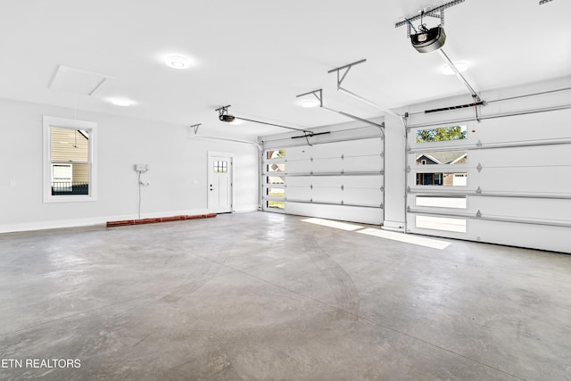 garage with baseboards and a garage door opener