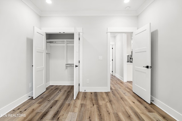 unfurnished bedroom featuring light wood finished floors, recessed lighting, and baseboards