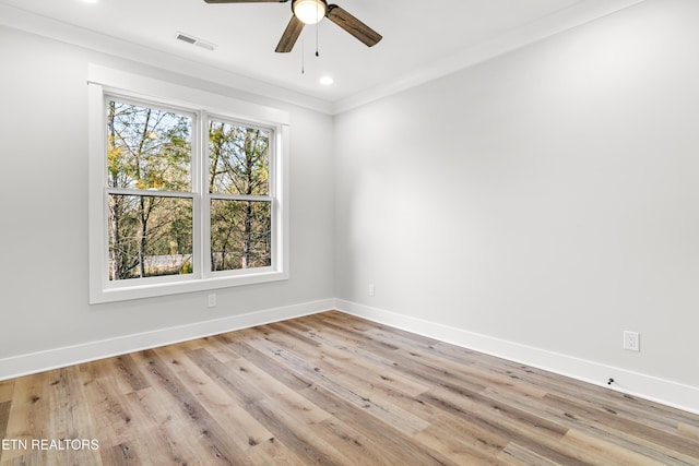 unfurnished room with light wood-type flooring, visible vents, and baseboards