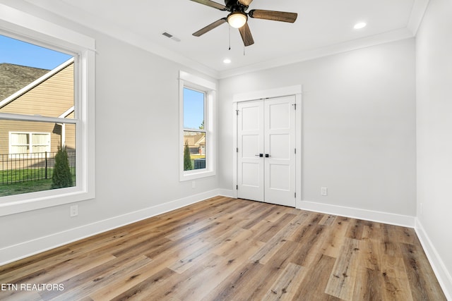 unfurnished bedroom with crown molding, recessed lighting, visible vents, wood finished floors, and baseboards