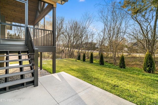 view of yard with a sunroom, stairway, and a patio