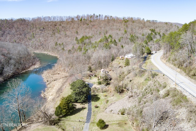 aerial view featuring a water view and a wooded view