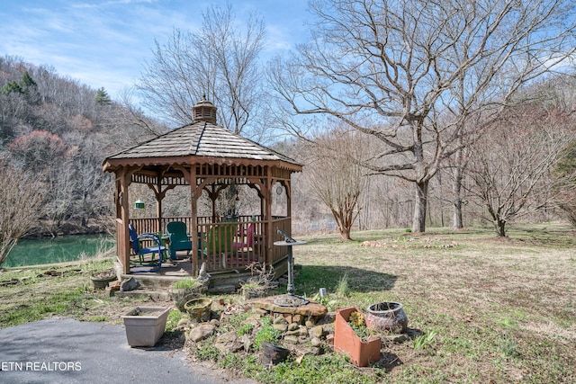 view of yard with a gazebo and a water view