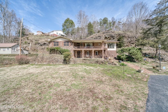 ranch-style home with brick siding and a front yard