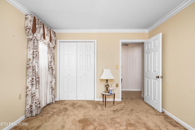 bedroom with crown molding, a closet, and carpet floors