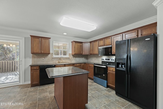 kitchen with black appliances, ornamental molding, a sink, a kitchen island, and backsplash