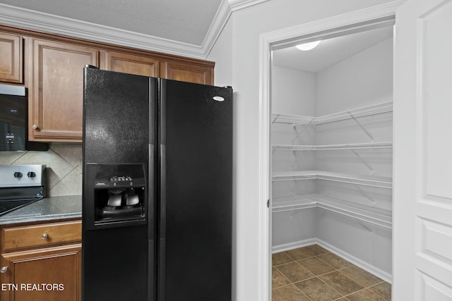 kitchen with dark countertops, brown cabinets, backsplash, and stainless steel appliances