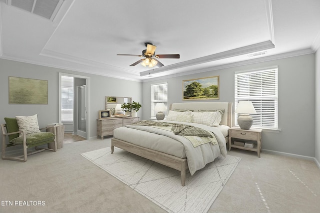 bedroom featuring visible vents, multiple windows, and a tray ceiling