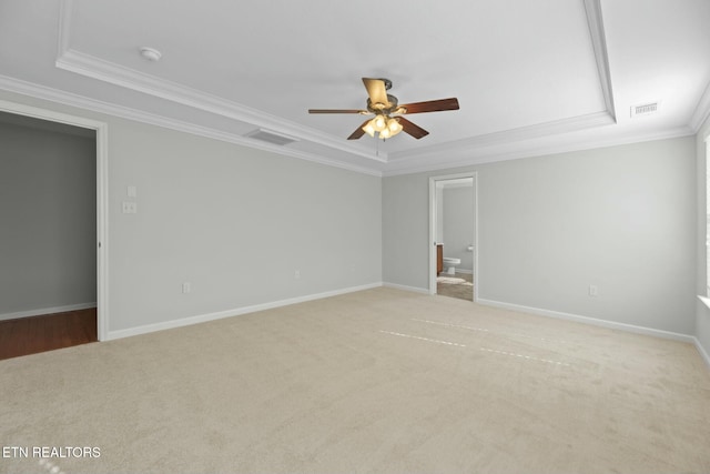 carpeted empty room featuring visible vents, baseboards, a ceiling fan, and ornamental molding