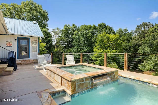 view of swimming pool featuring an in ground hot tub