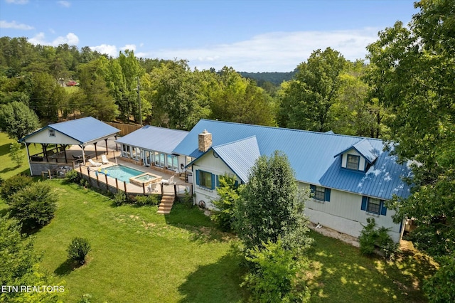 drone / aerial view featuring a forest view