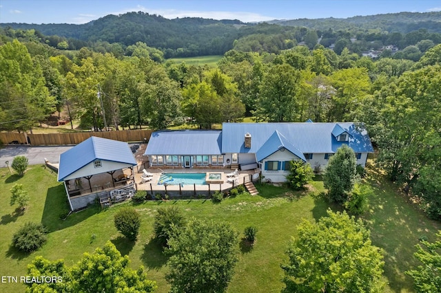 birds eye view of property featuring a view of trees