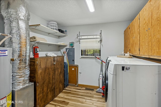 laundry area featuring cabinet space, light wood finished floors, water heater, and a textured ceiling