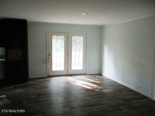 unfurnished room with wood finished floors