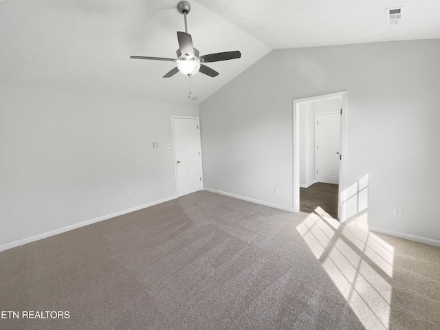 unfurnished room featuring carpet floors, baseboards, visible vents, and lofted ceiling