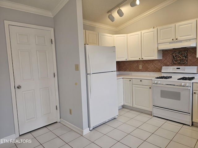 kitchen with light tile patterned flooring, under cabinet range hood, white appliances, decorative backsplash, and crown molding