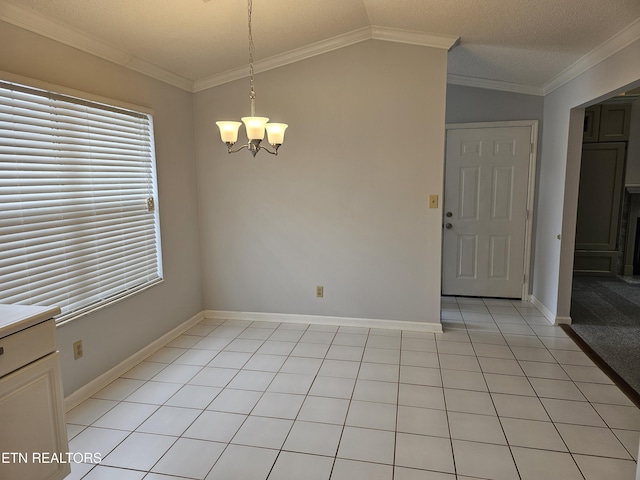 unfurnished room featuring a chandelier, lofted ceiling, light tile patterned flooring, baseboards, and crown molding