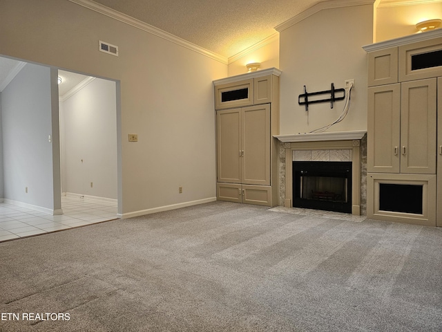 unfurnished living room with visible vents, light colored carpet, a premium fireplace, ornamental molding, and light tile patterned flooring