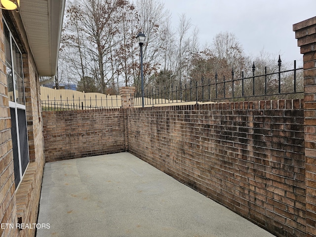 view of patio / terrace featuring fence