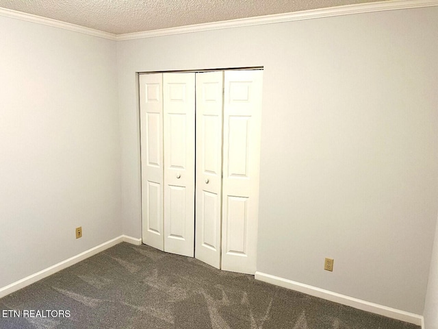 2442 Chastity Way, Knoxville, TN 37909 - unfurnished bedroom with dark carpet, a closet, a textured ceiling, ornamental molding, and baseboards