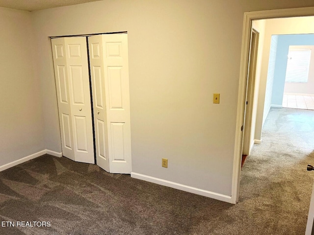 2442 Chastity Way, Knoxville, TN 37909 - unfurnished bedroom with dark carpet, baseboards, and a closet