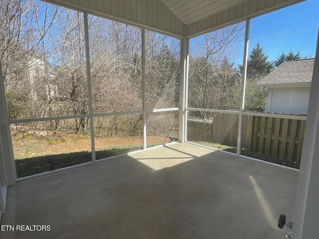 unfurnished sunroom with lofted ceiling