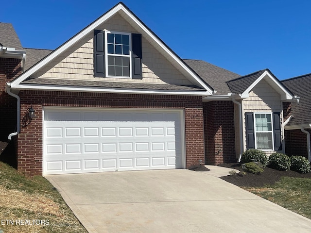 view of front of home featuring a garage, brick siding, concrete driveway, and a shingled roof