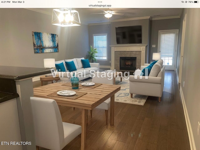 living area with dark wood-style floors, crown molding, and a wealth of natural light