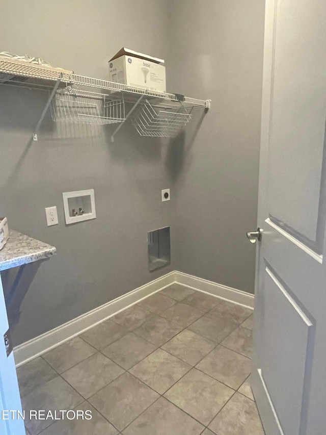 washroom with electric dryer hookup, tile patterned floors, baseboards, hookup for a washing machine, and laundry area