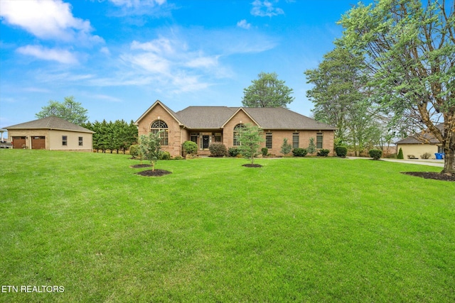 ranch-style home featuring a front lawn and brick siding