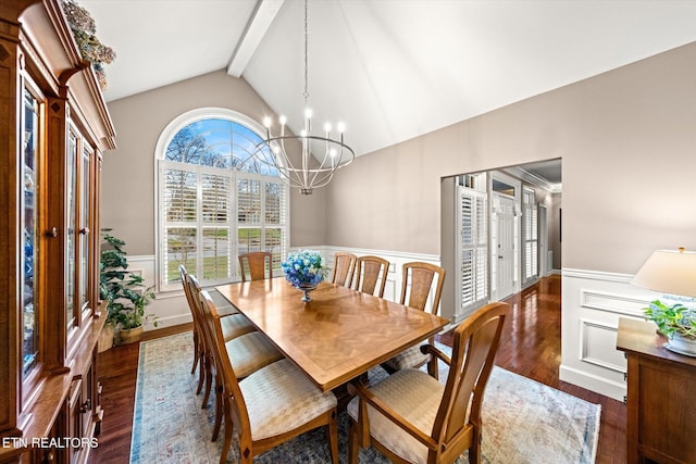 dining room with a chandelier, dark wood-style flooring, a wainscoted wall, and vaulted ceiling with beams