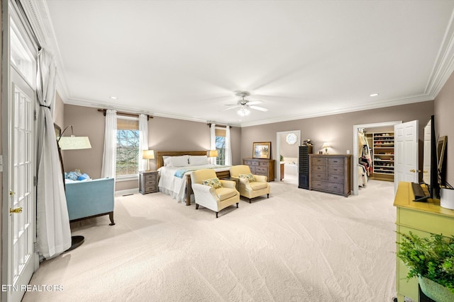 bedroom with a walk in closet, recessed lighting, ornamental molding, light carpet, and ceiling fan